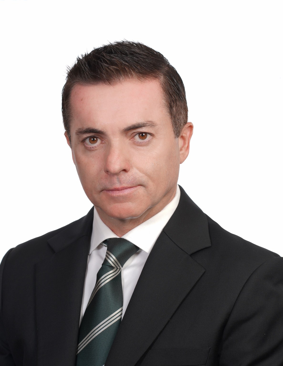 Formal professional headshot of James McLeary wearing a dark suit, white shirt and patterned tie.